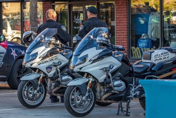 Police motorcycles parked in front of a downtown business